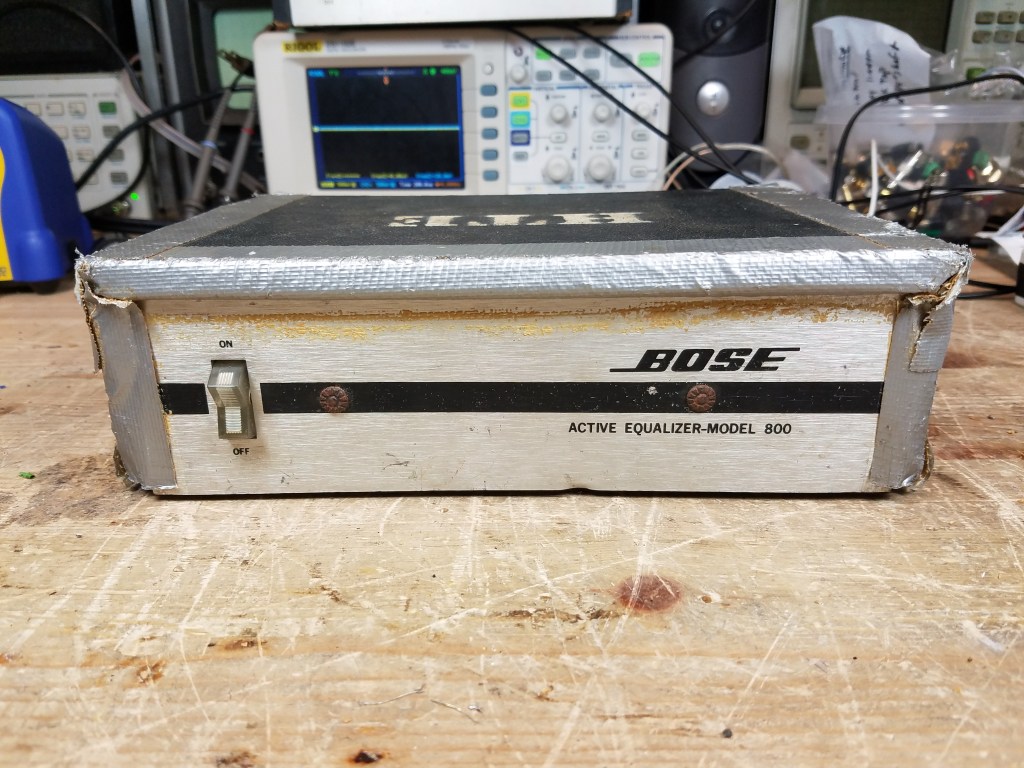 A badly banged up earlier 800 Active Equalizer, similar to a 901 Series 1, covered in duct tape and with spray painted markings on top.
