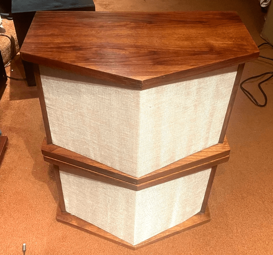 A rear view showing the same two speakers from the previous image, facing away.