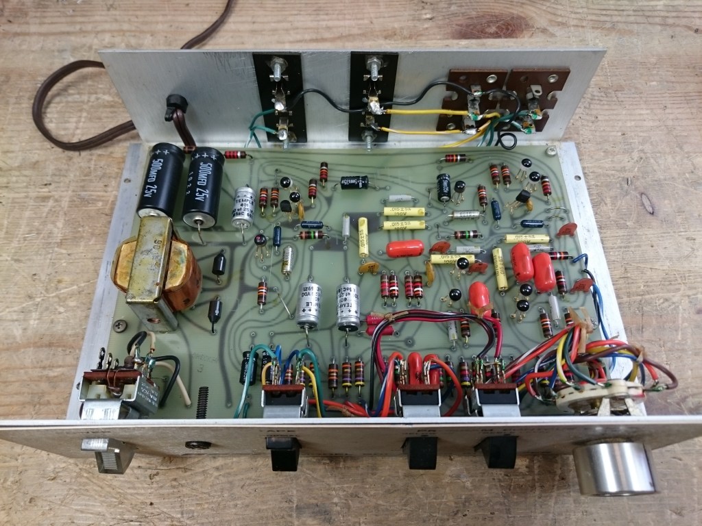 An inside view of the Series I Early Production equalizer, showing the original unreplaced components in chaotic alignment.