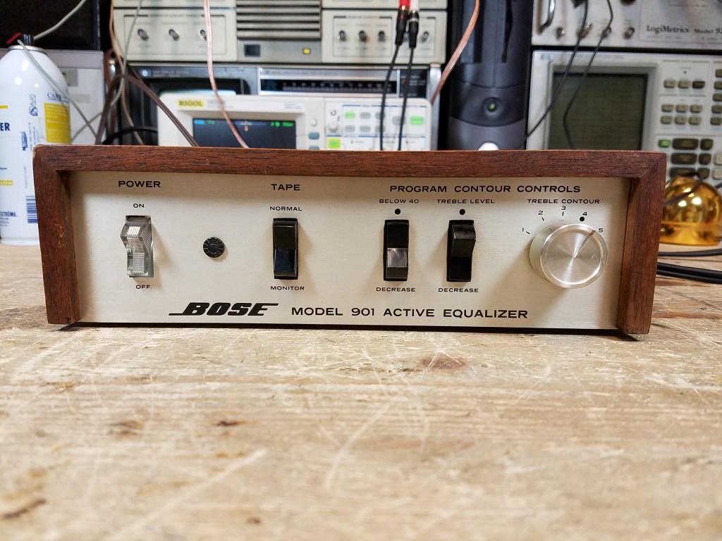 A wood case Bose 901 Series I active equalizer sitting on the workbench showing the front with controls.