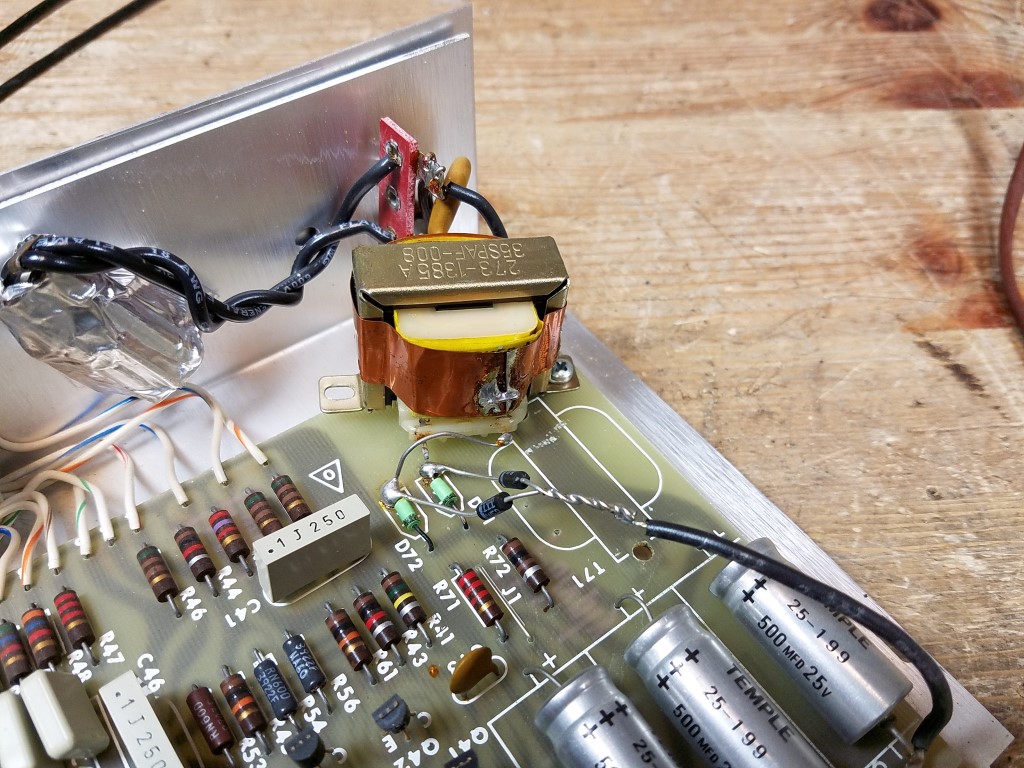 An interior view of a Series 2 equalizer with a modification to the power transformer; it's off-center (possibly from a Series 3) and held on by one screw, with mystery diodes connected to an unidentified wire and the unit's ground plane.