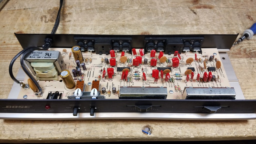 Tilted front view of the 901 Series V Active Equalizer on the repair bench showing replaced components.